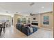 Open-concept living room featuring a fireplace, large windows, tile flooring, and neutral colors creates a spacious interior at 442 Anessa Rose Loop, Ocoee, FL 34761
