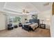 Spacious main bedroom with a tray ceiling, fan, sitting area, and lots of natural light at 442 Anessa Rose Loop, Ocoee, FL 34761