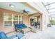 Covered patio with comfortable seating, ceiling fan, and sliding glass doors leading indoors at 442 Anessa Rose Loop, Ocoee, FL 34761