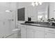 Modern bathroom features a glass-enclosed shower and a vanity with a sleek countertop and stylish fixtures, offering a spa-like experience at 4709 Flagstaff Ct, Orlando, FL 32820