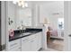 Bathroom view showcasing vanity with dark countertop, modern fixtures, and bedroom views with decorative elements at 4709 Flagstaff Ct, Orlando, FL 32820