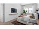 Bright bedroom with light wood floors, light colored walls, and a window offering a scenic view creates a serene and modern retreat at 4709 Flagstaff Ct, Orlando, FL 32820