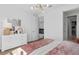 Bright bedroom features a modern light fixture and a stylish white dresser with a mirror above it at 4709 Flagstaff Ct, Orlando, FL 32820