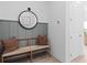 Cozy entryway featuring a bench with throw pillows, a decorative mirror, and modern wall paneling, creating a welcoming and stylish entrance at 4709 Flagstaff Ct, Orlando, FL 32820