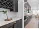 Contemporary kitchen featuring sleek, gray cabinetry, stainless steel appliances, and a wine rack at 4709 Flagstaff Ct, Orlando, FL 32820
