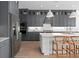 Modern kitchen featuring stainless steel appliances, an island, and sleek gray cabinetry at 4709 Flagstaff Ct, Orlando, FL 32820