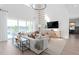 Bright living room with modern furnishings, large windows, and views of the pool and lake at 4709 Flagstaff Ct, Orlando, FL 32820