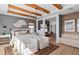Stunning main bedroom featuring wood beam ceilings, modern decor, and seamless access to a comfortable sitting area at 4709 Flagstaff Ct, Orlando, FL 32820