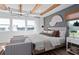 Spacious bedroom with ample natural light, modern decor, and seating area is perfect for relaxation and enjoying outdoor views at 4709 Flagstaff Ct, Orlando, FL 32820