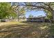 Large backyard featuring mature trees, a shed, and plenty of space for outdoor activities at 5144 Orange Ave, Winter Park, FL 32792