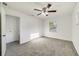 A bright bedroom is shown with neutral carpet and a ceiling fan for added comfort at 5144 Orange Ave, Winter Park, FL 32792