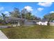 Charming single-story home with a carport and manicured lawn, complemented by a vibrant blue sky at 5144 Orange Ave, Winter Park, FL 32792