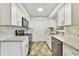 Modern kitchen featuring granite countertops, stainless steel appliances, and stylish backsplash at 5144 Orange Ave, Winter Park, FL 32792
