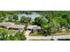 An aerial shot captures the home's setting near a lake and lush greenery at 5301 Pineview Way, Apopka, FL 32703