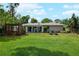 Backyard featuring a lush lawn, and mature landscaping at 5301 Pineview Way, Apopka, FL 32703