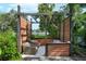 Secluded backyard retreat with comfortable wicker seating nestled within a wooden pergola structure at 5301 Pineview Way, Apopka, FL 32703