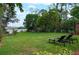Expansive backyard featuring a well-maintained lawn, trees, and lounge chairs perfect for outdoor relaxation at 5301 Pineview Way, Apopka, FL 32703
