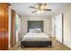 This bedroom offers wood floors, a ceiling fan, a large window, and a king bed at 5301 Pineview Way, Apopka, FL 32703