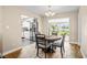 Bright dining area adjacent to kitchen with modern lighting and view to the backyard at 5301 Pineview Way, Apopka, FL 32703