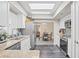 Spacious kitchen featuring white cabinetry, granite countertops, and stainless steel appliances overlooking dining area at 5301 Pineview Way, Apopka, FL 32703