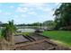 Beautiful lake view featuring a dock and garden beds, perfect for relaxation and gardening at 5301 Pineview Way, Apopka, FL 32703