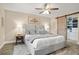 Serene main bedroom featuring a plush bed, sliding barn door to closet, and soft lighting at 5301 Pineview Way, Apopka, FL 32703