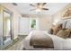 Bright main bedroom with a comfy bed, decorative mirror, and neutral color palette at 5301 Pineview Way, Apopka, FL 32703