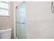 Bathroom shower with textured tile surround and glass door at 5301 Pineview Way, Apopka, FL 32703