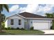 Charming single-story home featuring a well-maintained lawn and a two-car garage at 5925 Cliffbow Loop, Leesburg, FL 34748