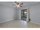 Bright bedroom with tile floors, sliding glass door leading to an outdoor space at 622 Mount Homer Rd # 622, Eustis, FL 32726
