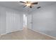 Neutral bedroom featuring a ceiling fan, large closet, and tile flooring for a simple, clean design at 622 Mount Homer Rd # 622, Eustis, FL 32726