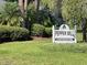 Pepper Mill Condominiums sign with manicured landscaping and mature trees creates an inviting community entrance at 622 Mount Homer Rd # 622, Eustis, FL 32726
