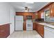 Well-equipped kitchen with tile floors, white appliances, wood cabinets, and ample counter space at 622 Mount Homer Rd # 622, Eustis, FL 32726