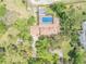 Aerial view showcasing a pool, surrounded by lush landscaping and a private backyard at 639 John Anderson Dr, Ormond Beach, FL 32176