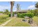 Cozy backyard cottage surrounded by greenery, with a stone bench, providing a serene escape at 639 John Anderson Dr, Ormond Beach, FL 32176