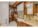 Traditional bathroom featuring wood cabinets, a window, and tile floors at 639 John Anderson Dr, Ormond Beach, FL 32176
