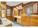 Classic bathroom with wood paneling, dual sinks, and vanity, offering a warm, luxurious space at 639 John Anderson Dr, Ormond Beach, FL 32176