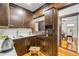The butler's pantry features dark wood cabinets and white countertops at 639 John Anderson Dr, Ormond Beach, FL 32176