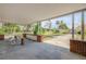 Covered carport with a concrete floor and brick supports, offering a shaded outdoor seating area with garden views at 639 John Anderson Dr, Ormond Beach, FL 32176