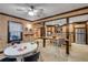 A spacious dining room featuring wood walls and tiled floors open to kitchen at 639 John Anderson Dr, Ormond Beach, FL 32176