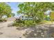 View of the white home with blue shutters and a detached garage on a large lot at 639 John Anderson Dr, Ormond Beach, FL 32176