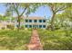 Charming two-story white home with blue shutters and a well-manicured front yard at 639 John Anderson Dr, Ormond Beach, FL 32176