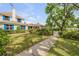 Charming home with a brick facade, blue shutters, a lush front lawn, and a stone walkway to the front entrance at 639 John Anderson Dr, Ormond Beach, FL 32176