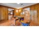 Inviting game room featuring wood paneling, brick floors, and an opening to the other spaces of the home at 639 John Anderson Dr, Ormond Beach, FL 32176