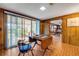 Spacious game room featuring wood paneling, brick floors, and sliding glass doors to the exterior at 639 John Anderson Dr, Ormond Beach, FL 32176