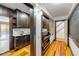 Hallway view into a butler's pantry showcasing beautiful wood cabinets and access to the backyard pool area at 639 John Anderson Dr, Ormond Beach, FL 32176