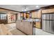 A kitchen features wood cabinets, stainless steel appliances, and a tile floor at 639 John Anderson Dr, Ormond Beach, FL 32176