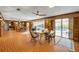 The cozy living room offers a view of the pool, wood paneling, and brick floors at 639 John Anderson Dr, Ormond Beach, FL 32176