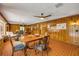 The spacious living room features wood paneling and tile flooring, with plenty of room for seating and dining at 639 John Anderson Dr, Ormond Beach, FL 32176