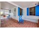 This brick patio is accented with bright blue shutters and offers shady seating at 639 John Anderson Dr, Ormond Beach, FL 32176